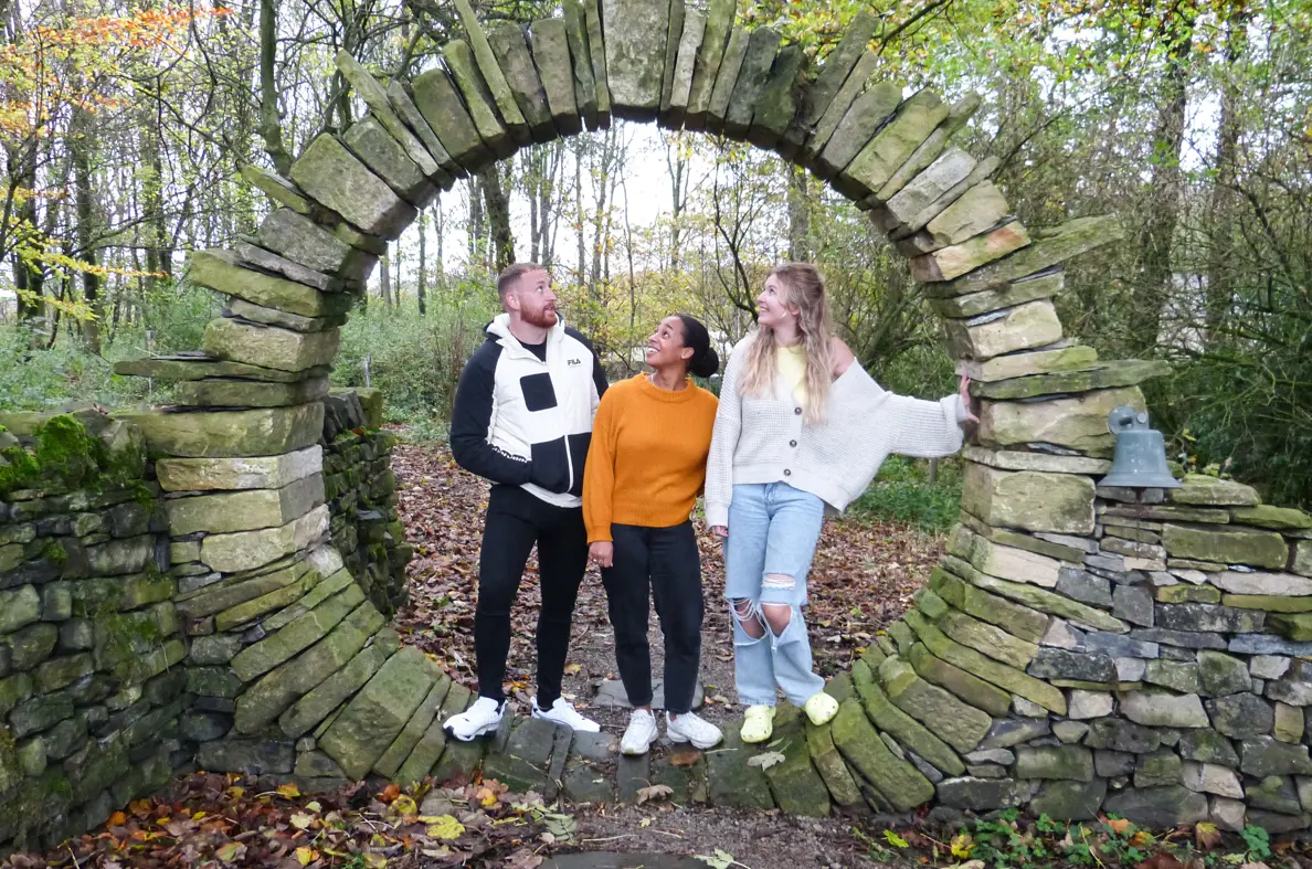 3 People Standing In Archway