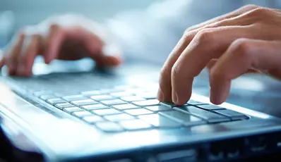 Laptop with someone pressing the keyboard