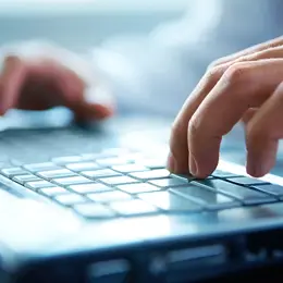 Laptop with someone pressing the keyboard
