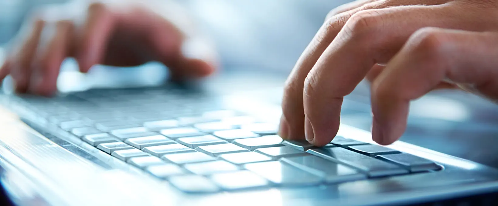 Laptop with someone pressing the keyboard