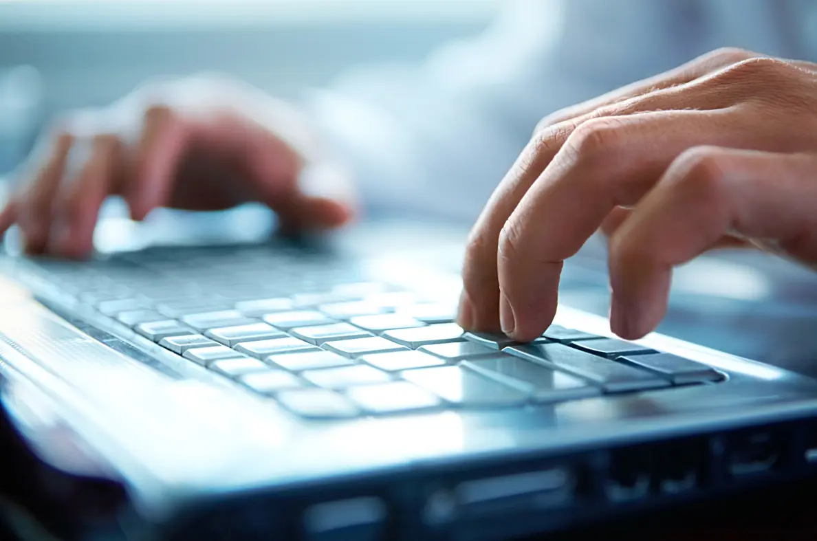 Laptop with someone pressing the keyboard