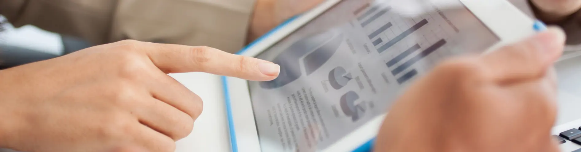 Multiple people around an ipad