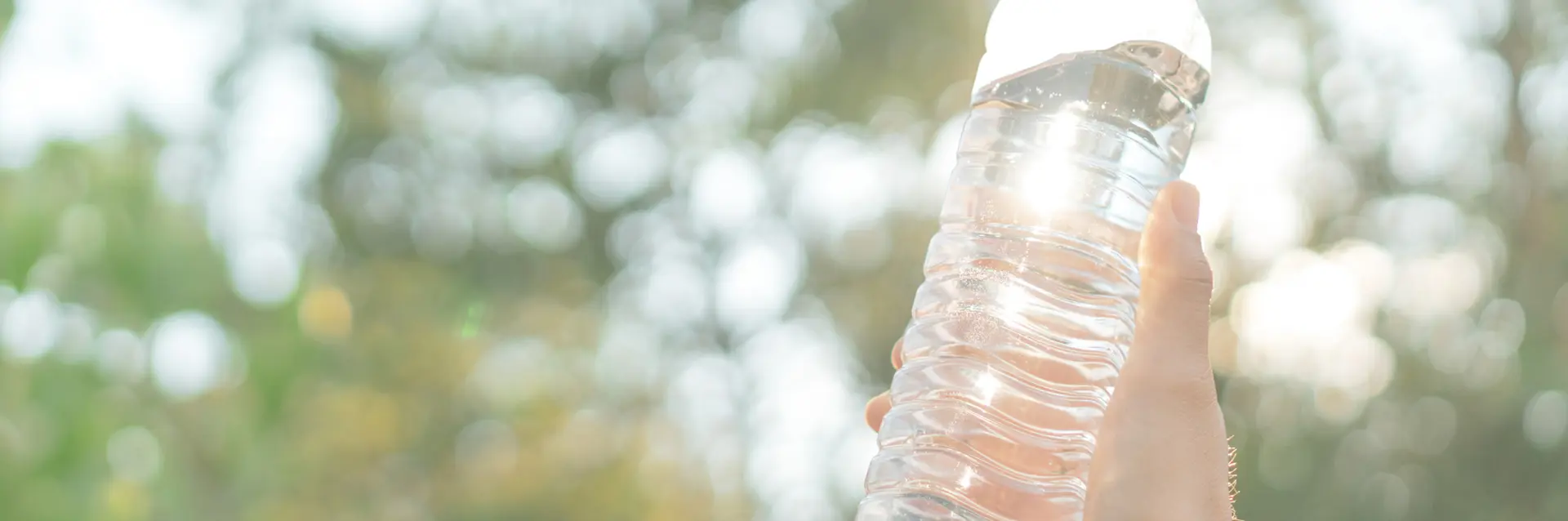 Someone holding up a plastic bottle