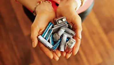 Women holding batteries in both hands