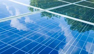 Solar Panels showing reflection of the sky with clouds